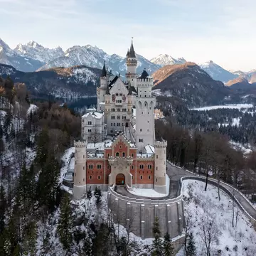 A scenic shot of the Neuschwanstein Castle in Germany surrounded by snowy mountain forests, License Type: media, Download Time: 2025-12-10T14:58:00.000Z, User: rhylton_redventures, Editorial: false, purchase_order: 65050 - Digital Destinations and Articles, job: Lonely Planet, client: social, other: Rhianydd Hylton