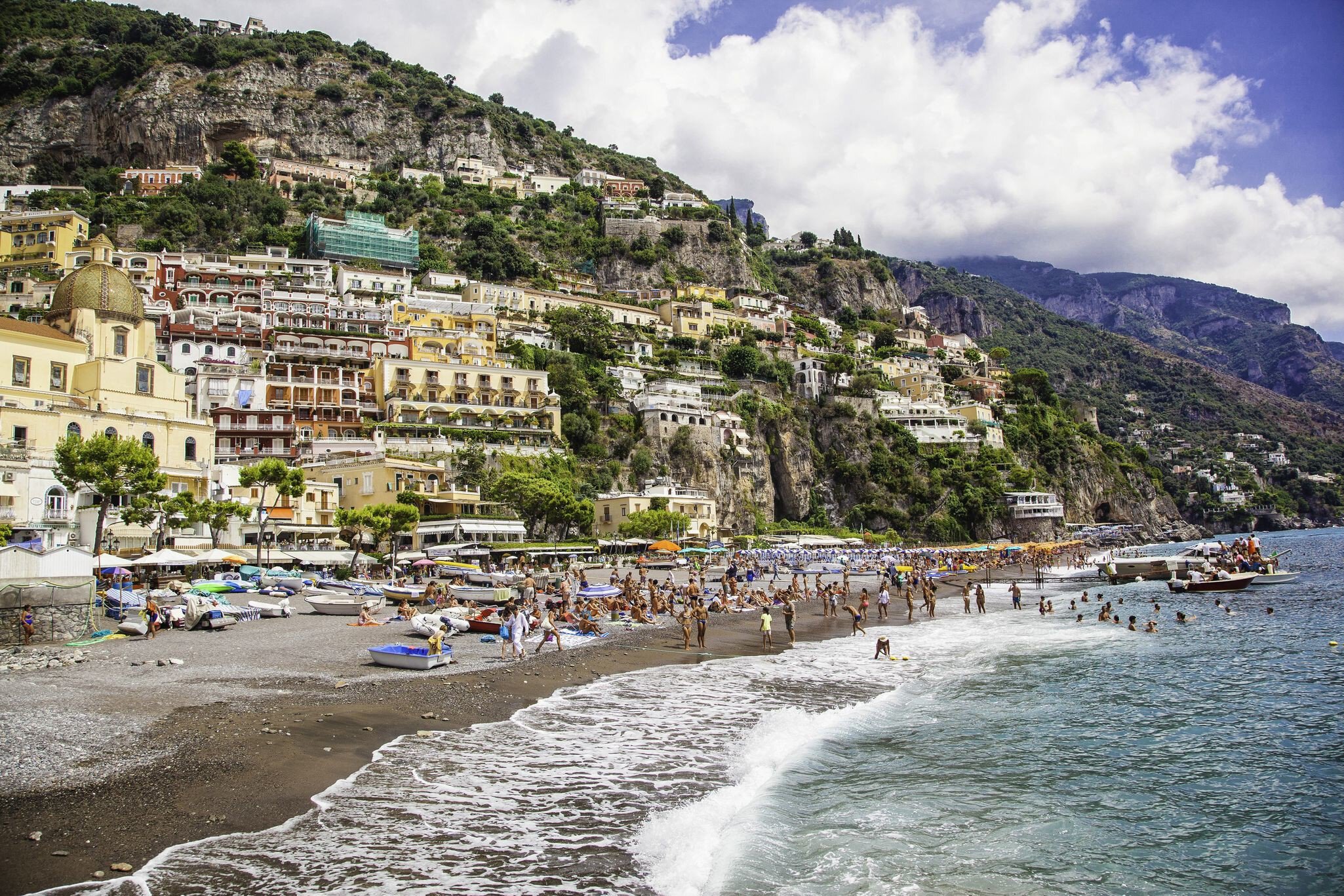 Beaches, like this one in Positano, are a relaxed place to chat to locals and other travellers. Benoit BACOU / Getty Images