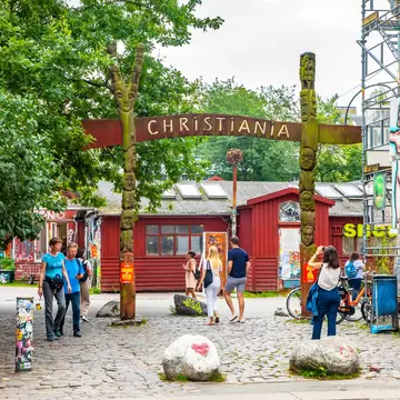 Copenhagen, Denmark. Entrance to Christiania Freetown commune with people walking.