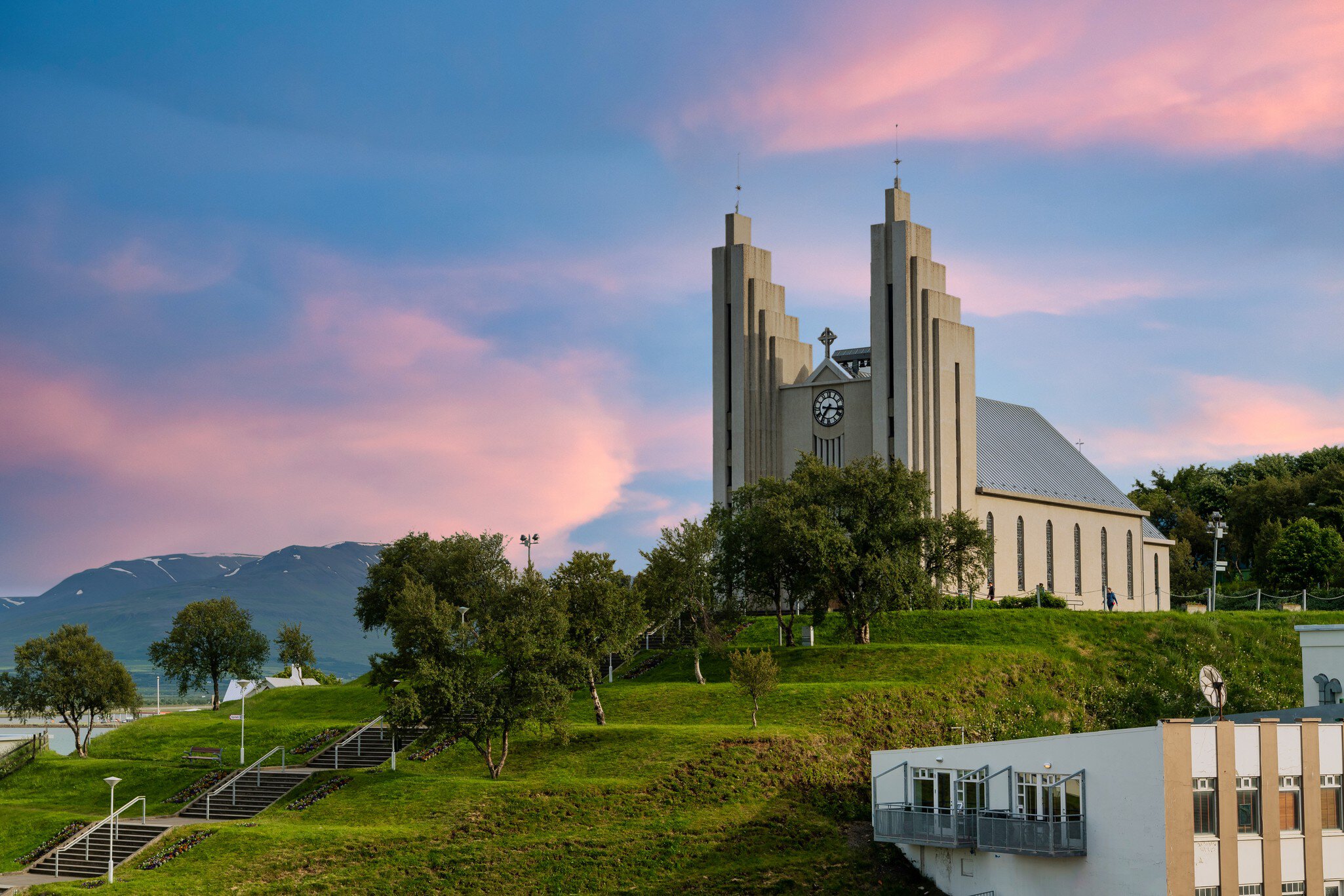 Akureyrarkirkja Lutheran Church This is an important and popular landmark of Akureyri city in Northern Iceland, in the evening sky blue vanilla. In the summer there are trees and green grass.  License Type: media  Download Time: 2023-08-02T15:34:23.000Z  User: FergalCo  Is Editorial: No  purchase_order:   