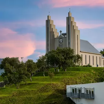 Akureyrarkirkja Lutheran Church This is an important and popular landmark of Akureyri city in Northern Iceland, in the evening sky blue vanilla. In the summer there are trees and green grass.  License Type: media  Download Time: 2023-08-02T15:34:23.000Z  User: FergalCo  Is Editorial: No  purchase_order:   