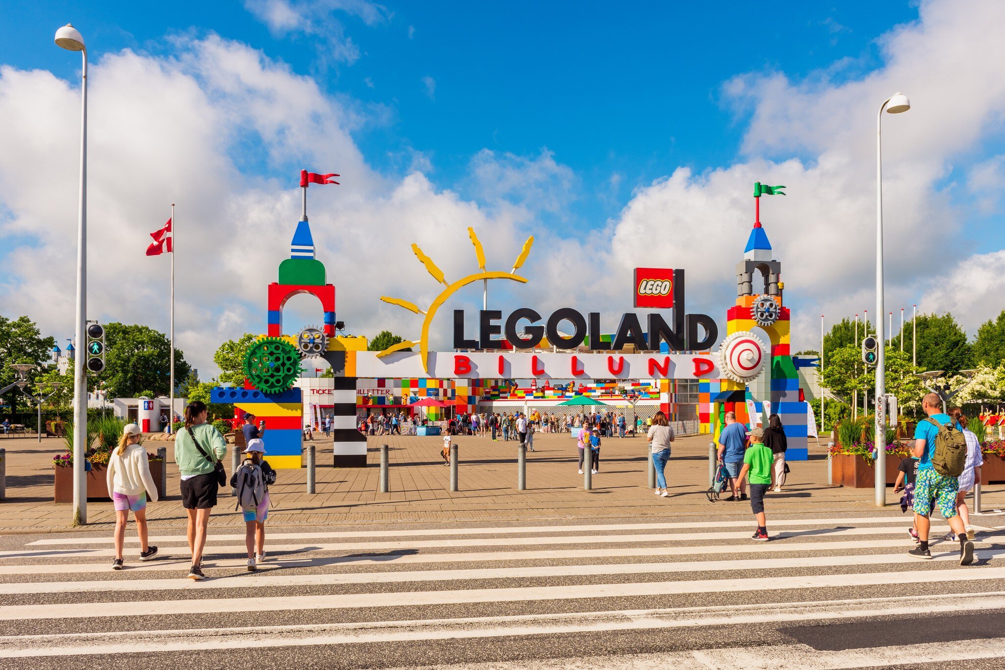 Kids and adults approac the bright, colorful entry to Legoland Amusement Park in Billund, Denmark