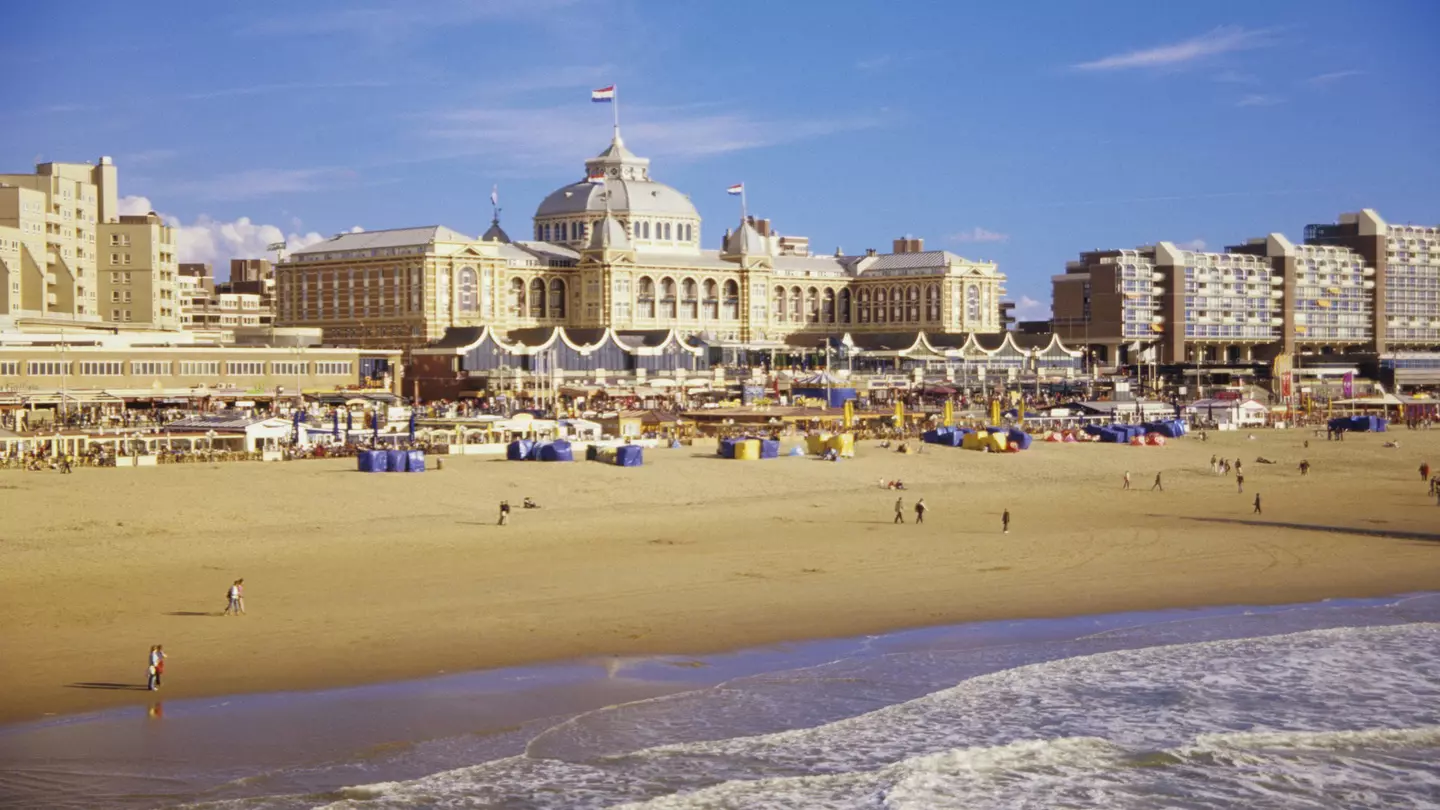Beachgoers in front of the iconic Kurhaus on the sands of Scheveningen
