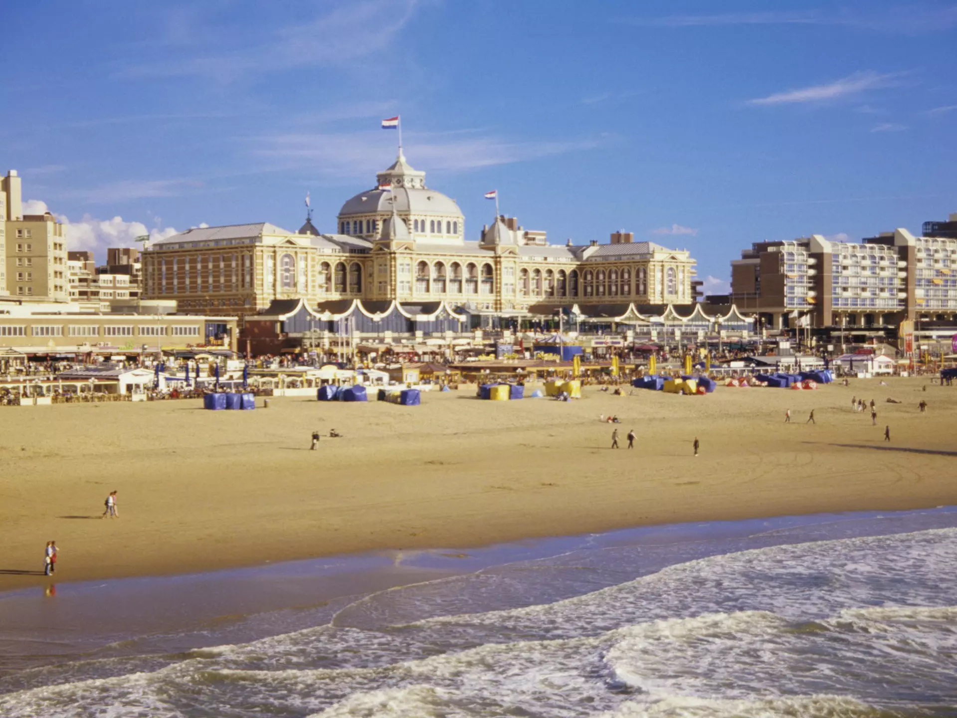 Beachgoers in front of the iconic Kurhaus on the sands of Scheveningen