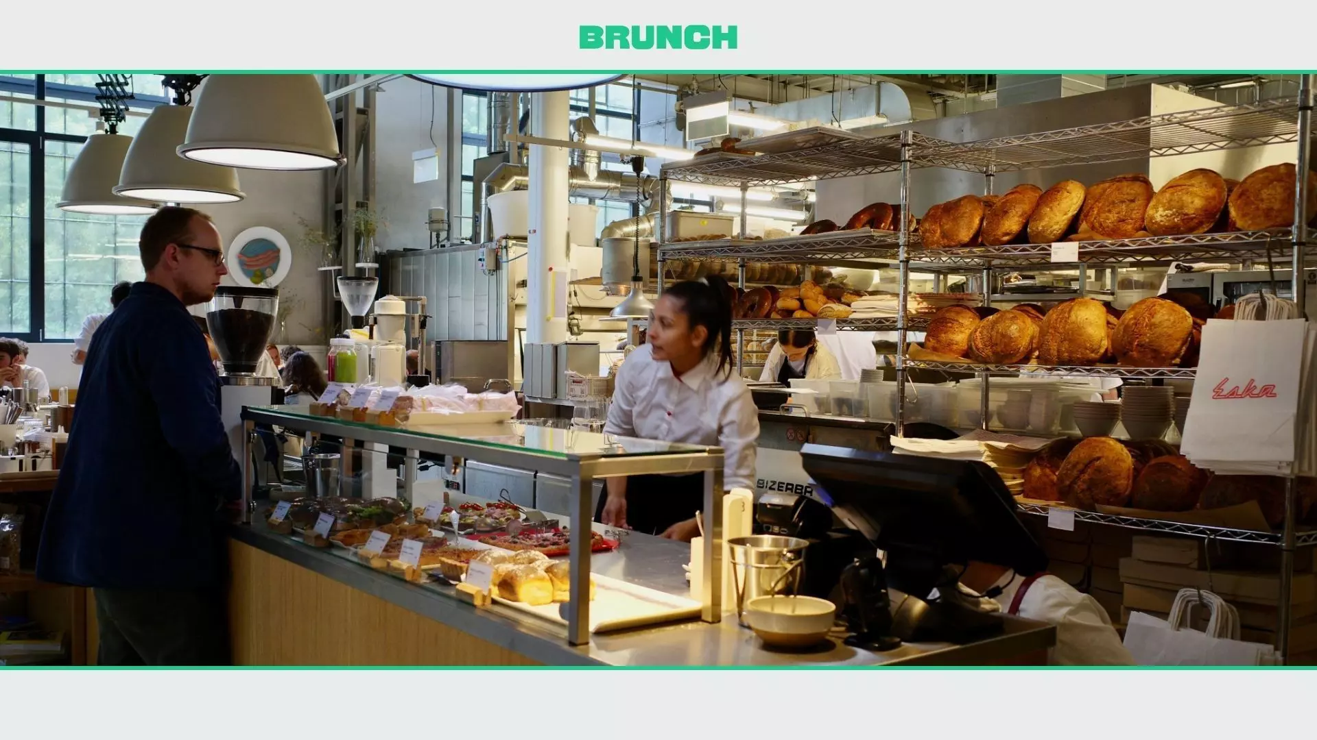 A customer is ordering at a busy bakery in Prague