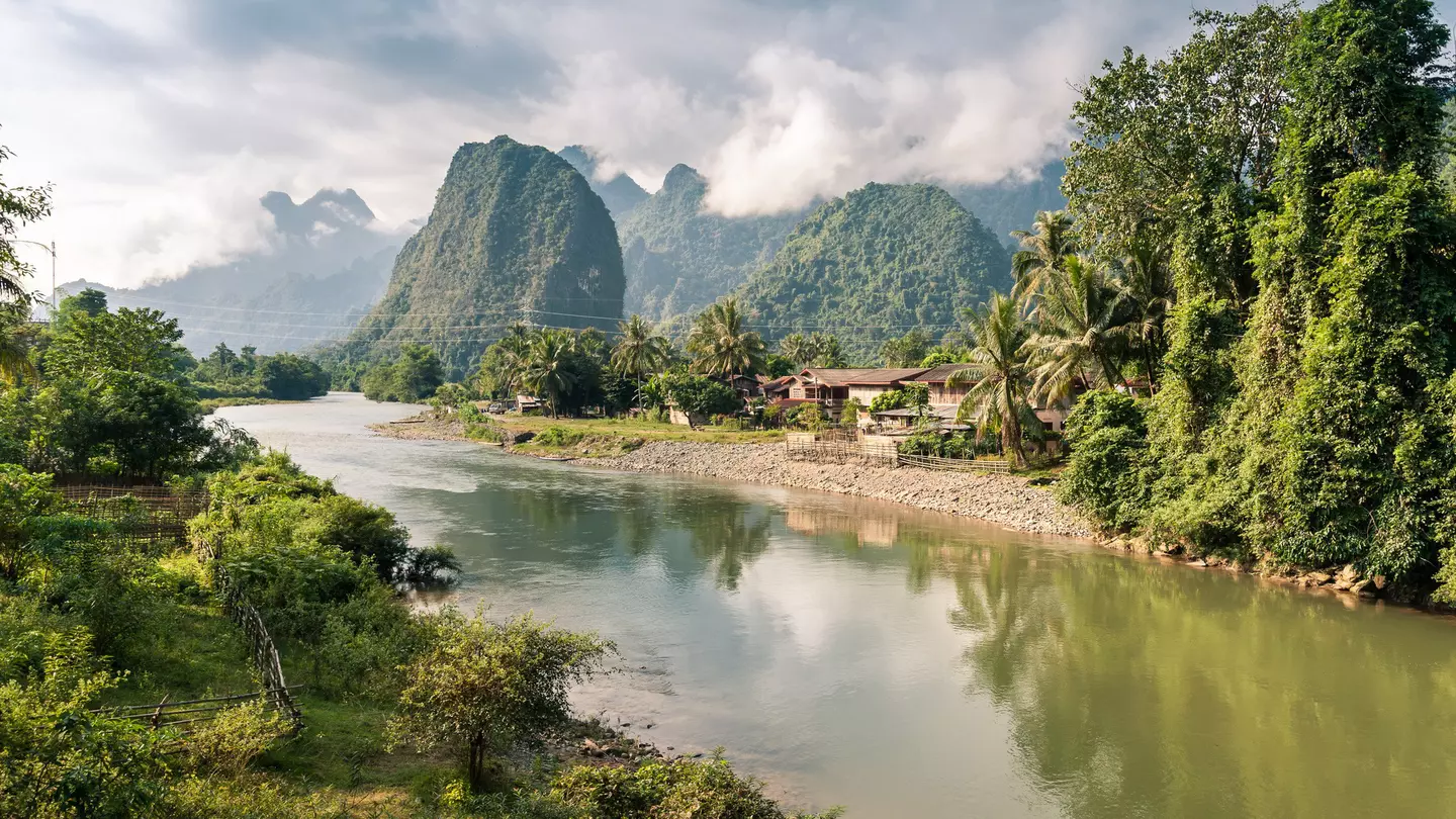 Karst mountains and jungle along a river.