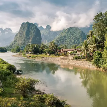 Karst mountains and jungle along a river.