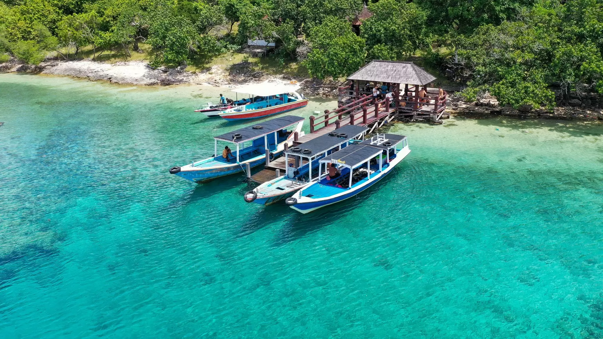 Boats parked next to the shore on Menjangan Island in Bali, Indonesia. 