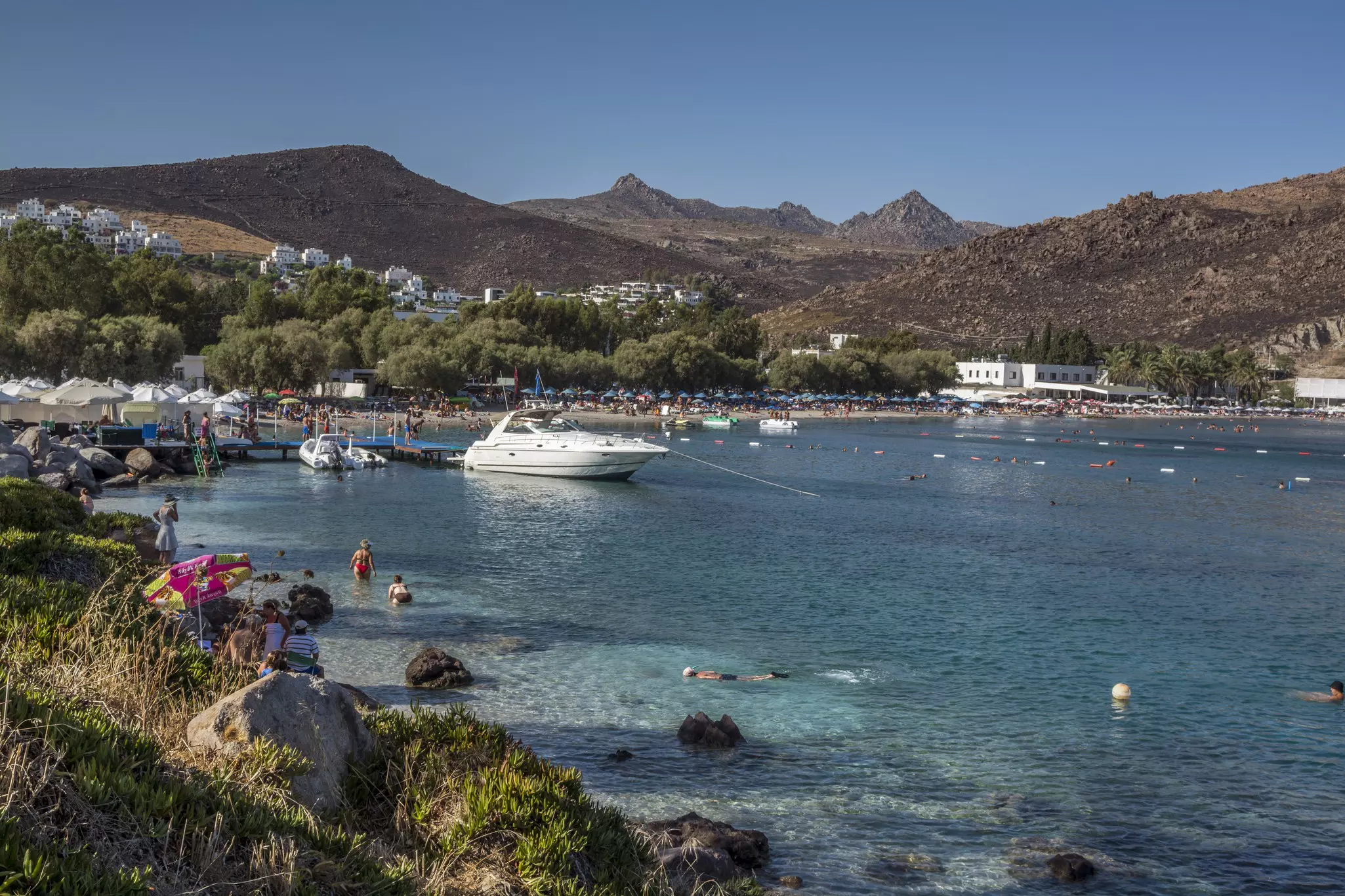 A harbor filled with sea-splashing holidaymakers and boats