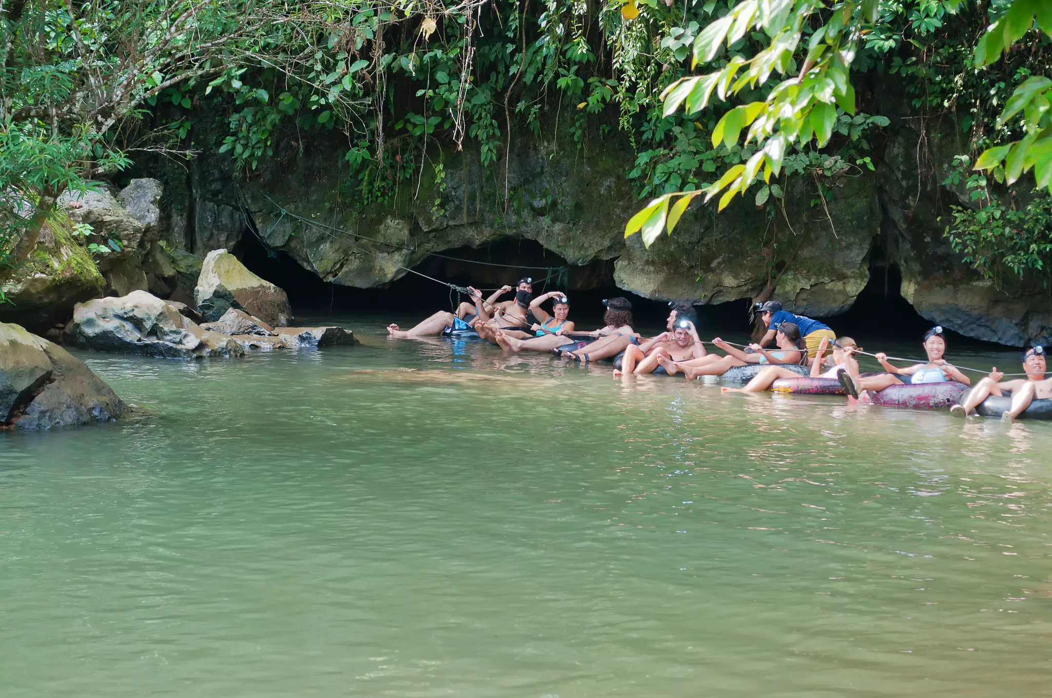 A group of tourists cave tubing in Vang Vieng. 