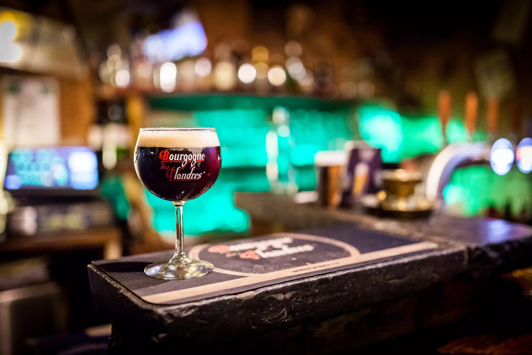 Glass of Bourgogne des Flandres, Belgian beer, on bar