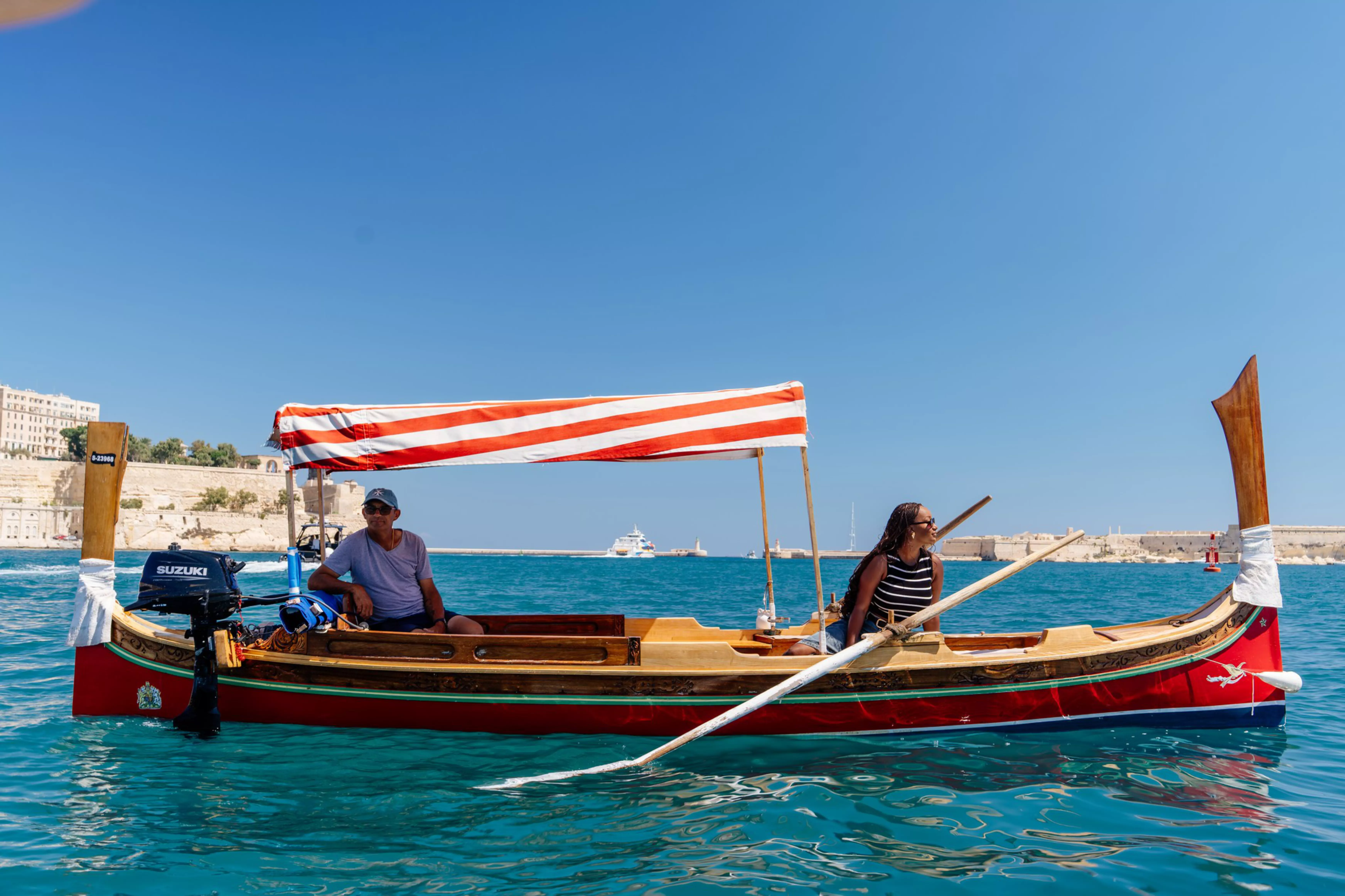 Jacklynn riding in a traditional Dgħajsa tal-pass boat.