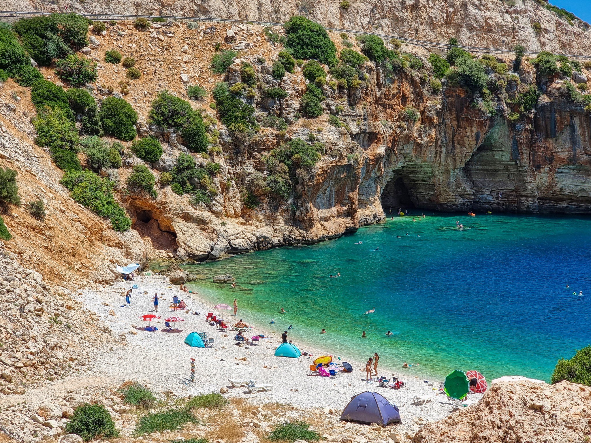 Antalya, Finike, Turkey July 26, 2023: Cave on the Demre - Finike road. Detail of eroded rock. Tourists swim and sunbathe here. Kaş, Antalya, Türkiye, License Type: media, Download Time: 2024-08-02T08:08:23.000Z, User: catalinaaragon, Editorial: true, purchase_order: 56530, job: Global Publishing-WIP, client: Turkey 17, other: CatalinaAragón