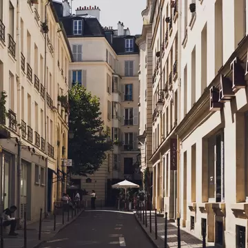 A quiet street in Paris lined with classic French style buildings