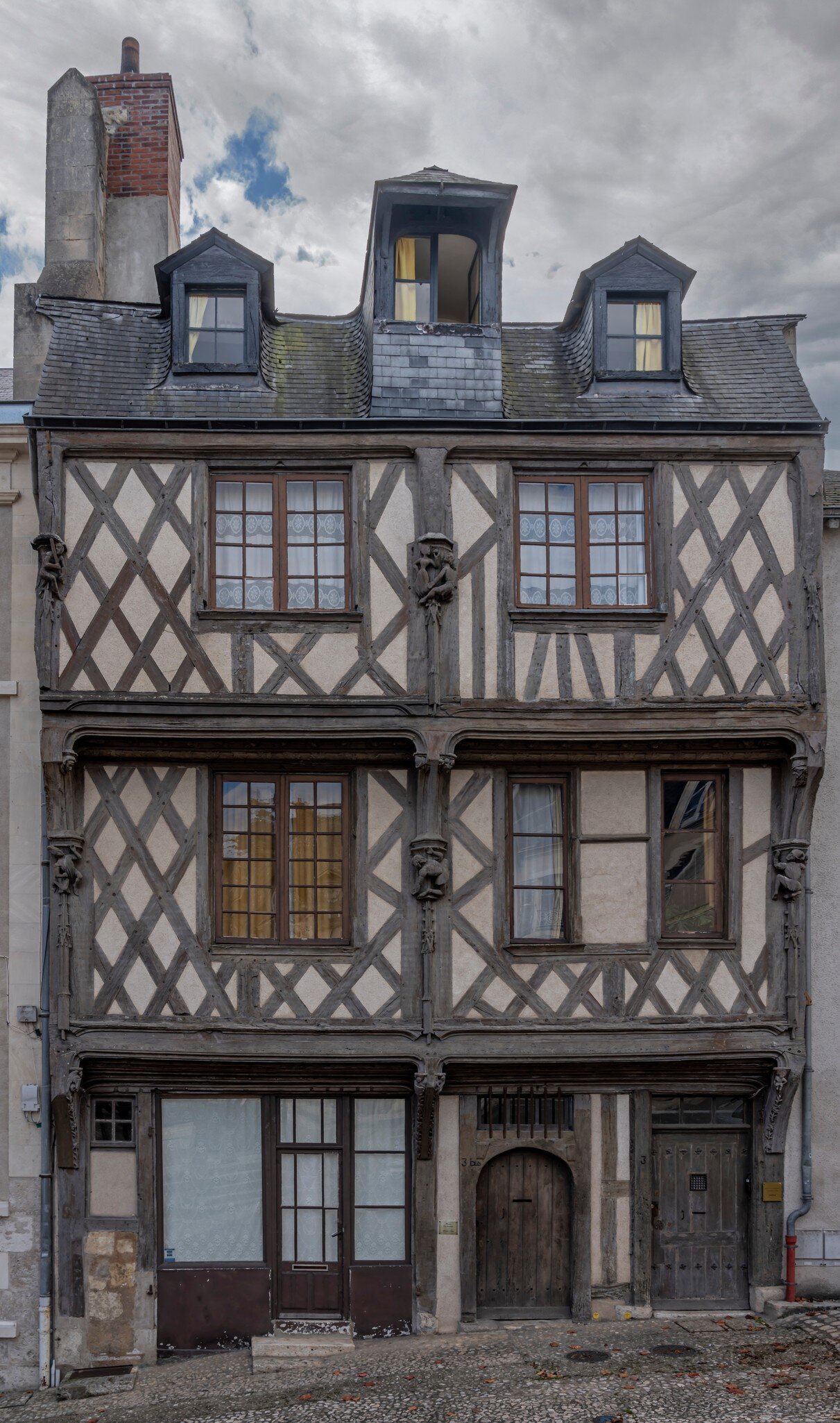 Facade of the acrobats' house (Maison des Acrobates); two corbelled upper storeys with brackets and corbelling. Loire Valley, France.
