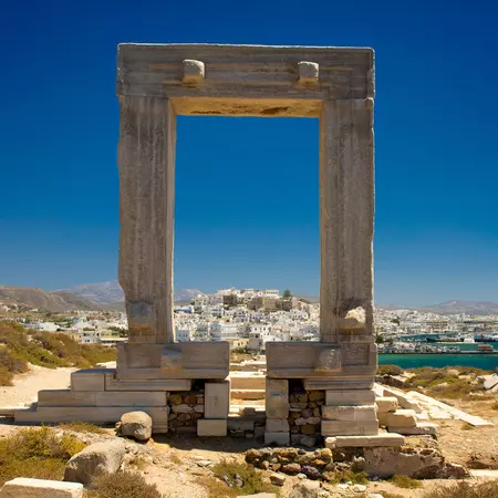 Greek ruins overlooking a whitewashed town