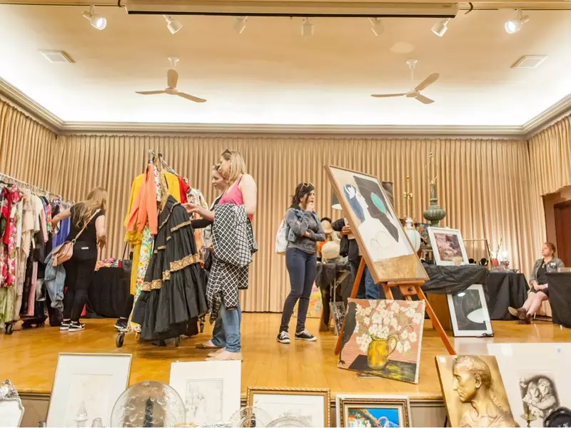Shoppers and racks of clothes inside Randolph Street Market.