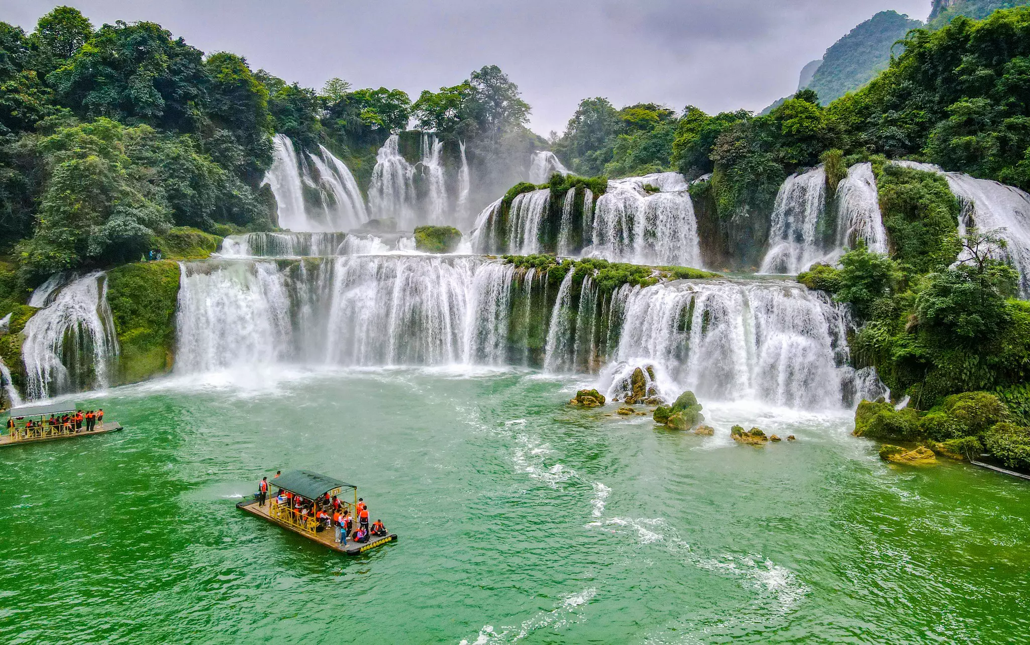 View of Ban Gioc waterfall with rafts in the foreground, Cao Bang, Vietnam.