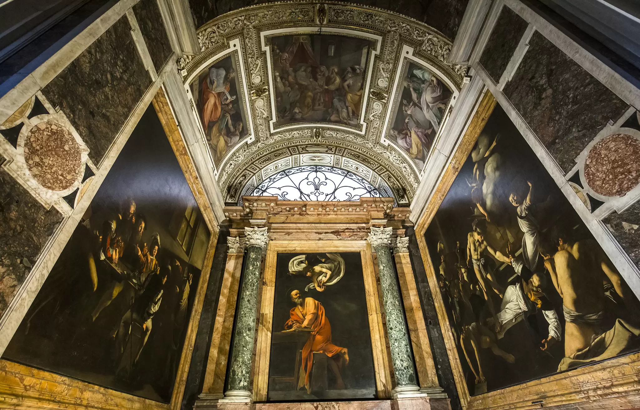 A series of paintings covering the walls and ceiling of a church