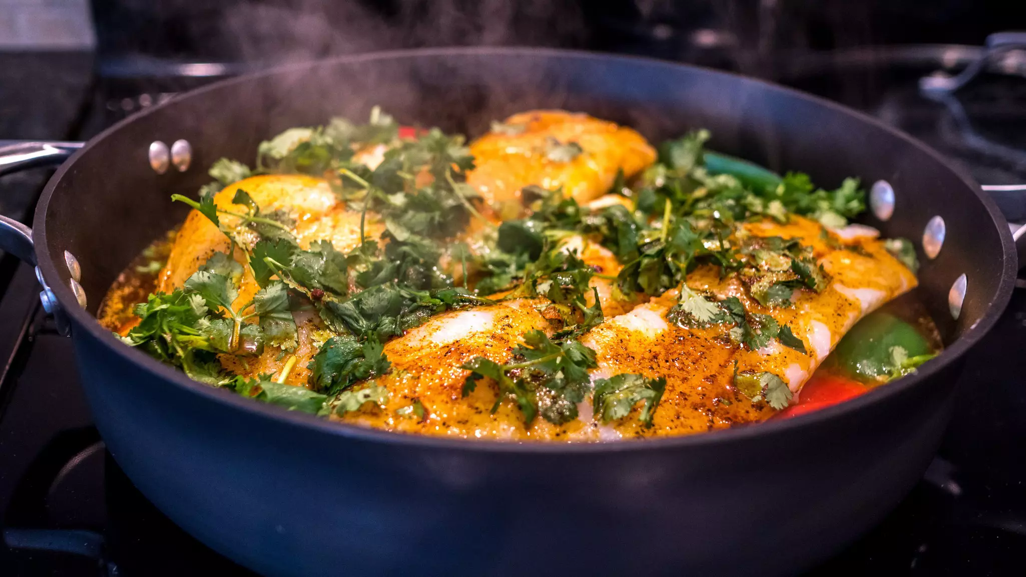 Traditional fish chermoula covered with herbs on the stove. LEA GAMPEL/Shutterstock