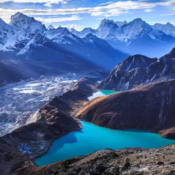 Stunning view of the Himalaya mountains (Cholatse and Taboche to the left), Ngozumpa glacier, and Gokyo lakes (the world's highest freshwater lakes, sacred for both Hindus and Buddhists), as seen on top of Gokyo Ri (5,357 m), near the village of Gokyo, in Sagarmatha National Park, UNESCO World Heritage Site in Khumbu region, Solukhumbu district, eastern Nepal, Asia.
Asia; Beauty In Nature; Blue; Cloud - Sky; Cold Temperature; Color Image; Day; Dusk; Gokyo; Gokyo Lake; Gokyo Peak; High Angle View; Himalayas; Horizontal; Khumbu; Lake; Landscape; Majestic; Mountain; Mountain Range; Nature; Nepal; No People; Outdoors; Photography; Reflection; Sagarmāthā National Park; Scenics; Sky; Snow; Snowcapped Mountain; Solu Khumbu; Standing; Sunlight; Tranquility; Travel Destinations; Turquoise Colored; UNESCO World Heritage Site; Village; Winter;