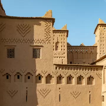 A tan building with designs etched into it