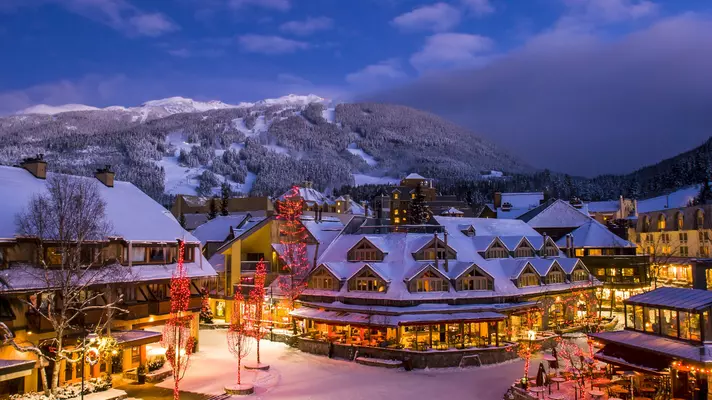 A snow-covered village with chalet-style restaurants