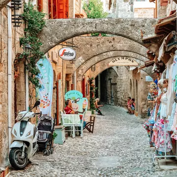 RHODES, GREECE - JULY 4, 2022: Street of the old town with shops in Turkish quarter inRhodes city in Greece; Shutterstock ID 2189036733;
