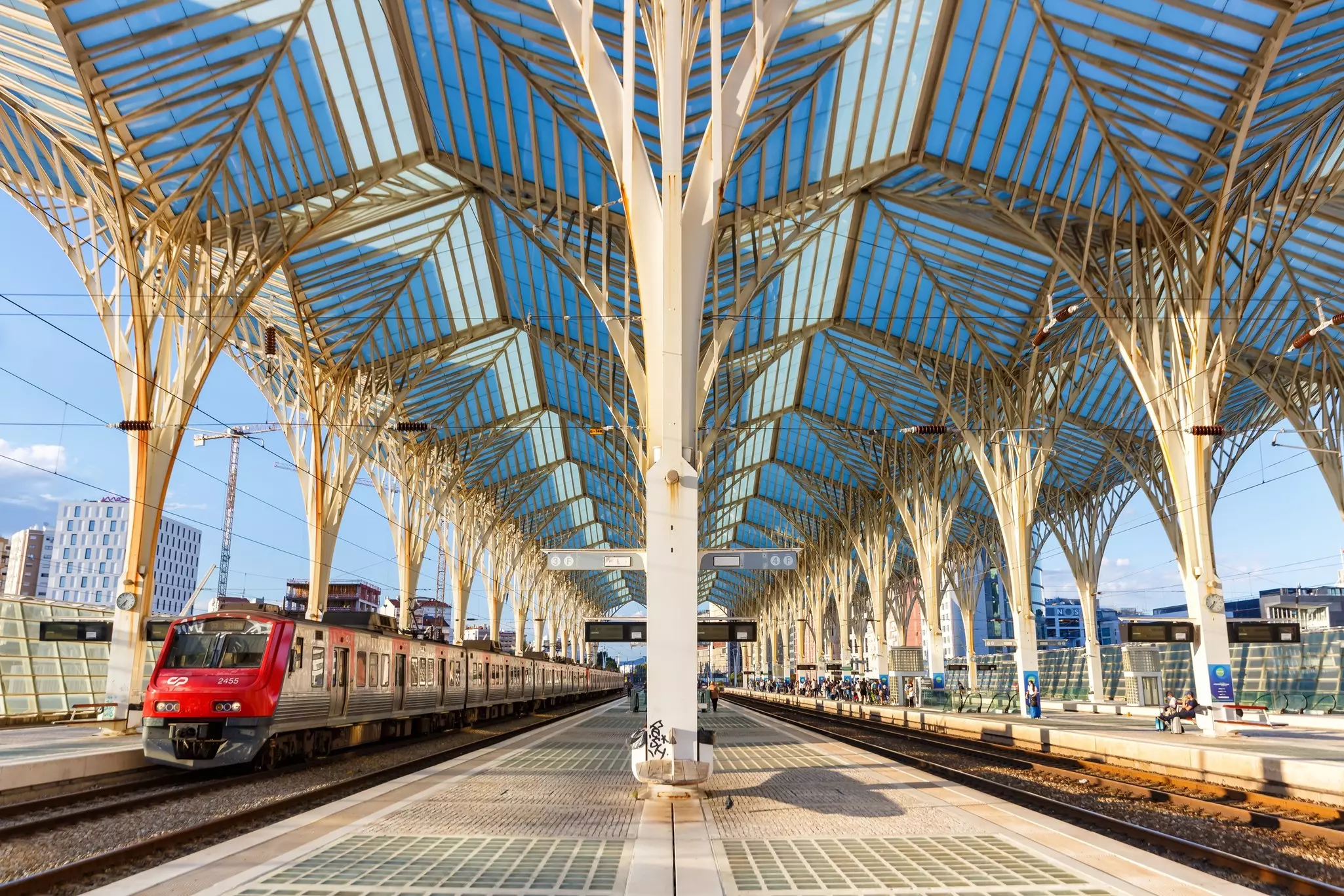 A red train rolls into Lisboa Oriente railway station in Lisbon, Portugal.