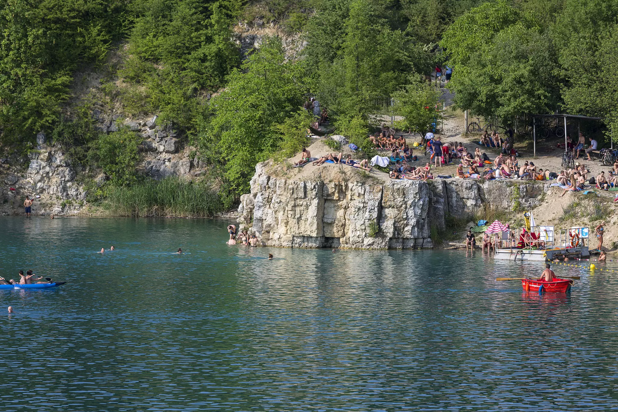 Lagoon Zakrzowek in an old limestone quarry, emerald water, resting people