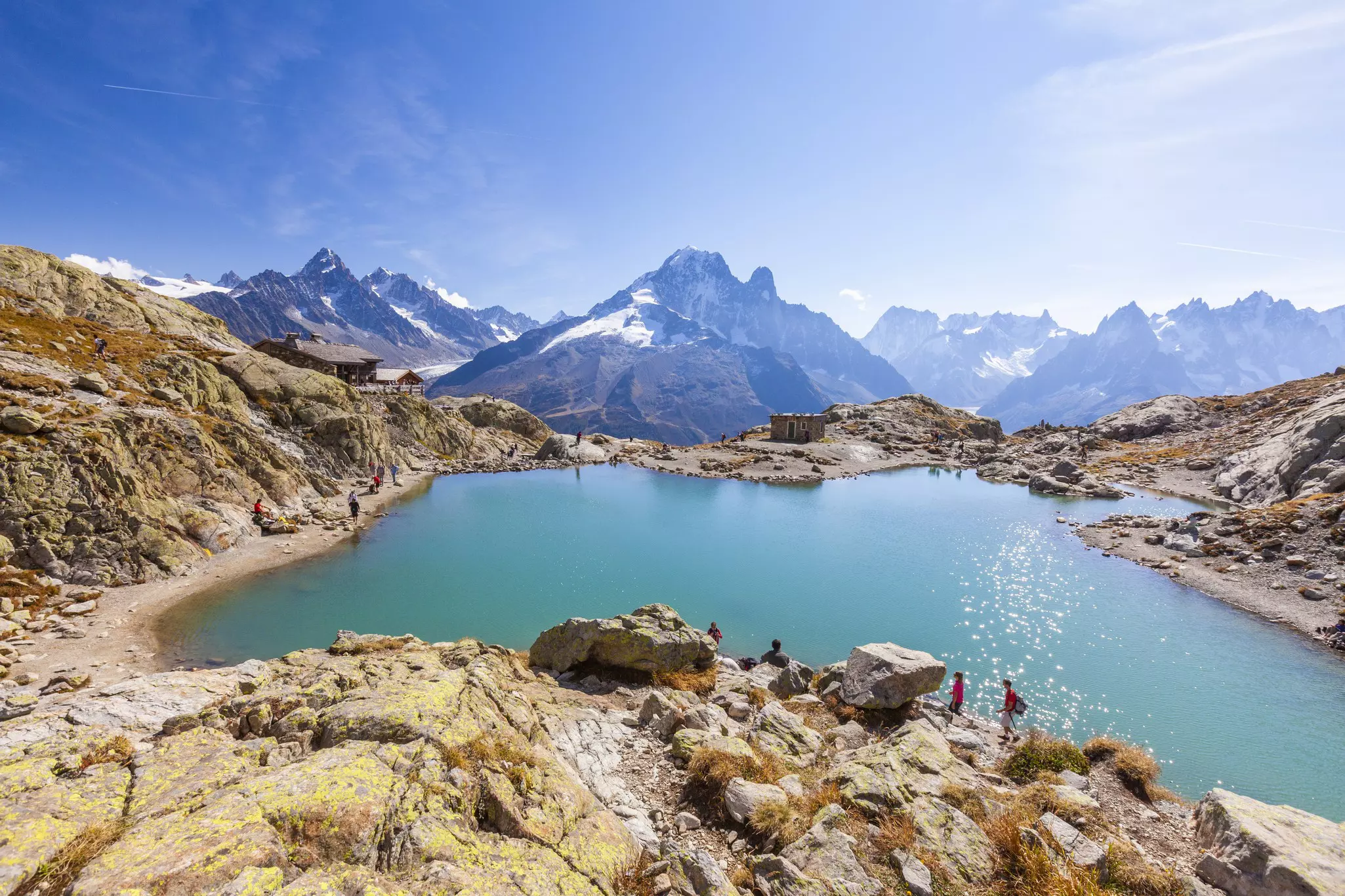 Hikers on footpath on the shore of Lac Blanc, Chamonix, Haute Savoie, France