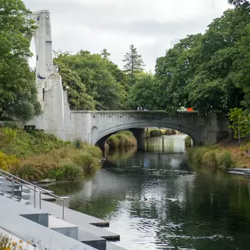 A group of people standing on a bridge above the Avon River in North Hagley Park, Christchurch.