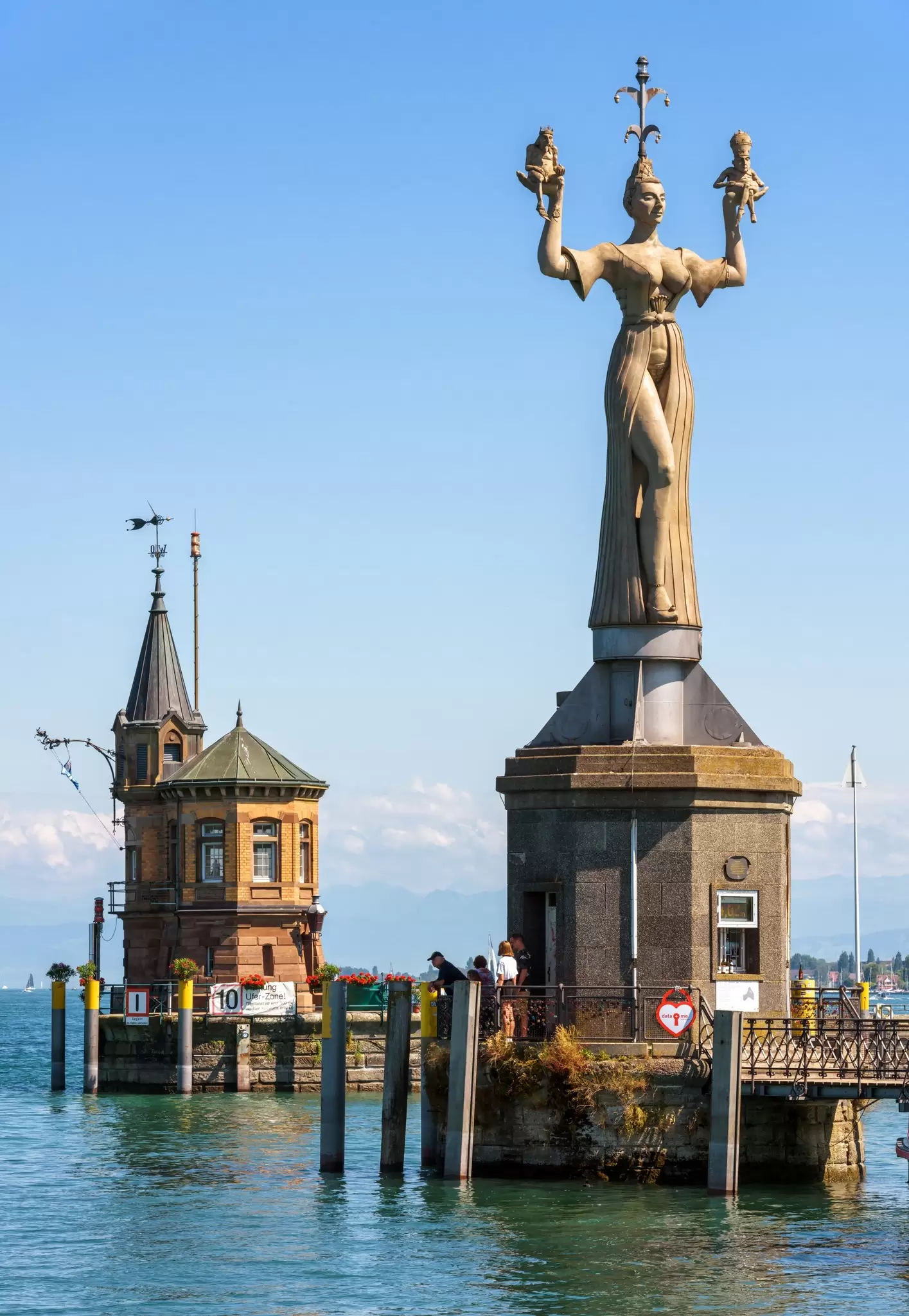 Imperia statue and old lighthouse tower at the harbour entrance of Konstanz on Lake Constance