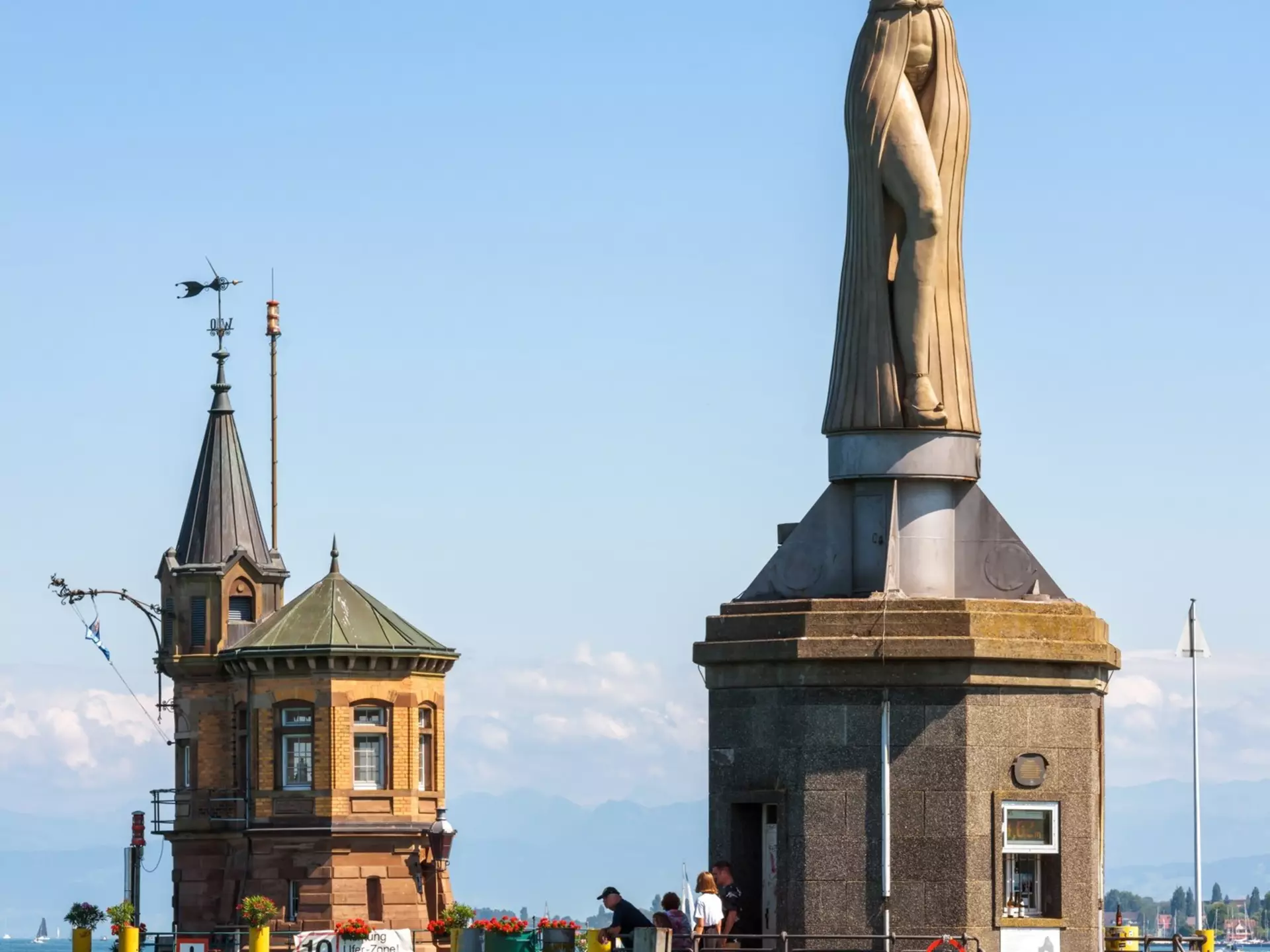 Constance, Germany - July 30, 2019: Old lighthouse and statue of Imperia in harbor of Konstanz. Sculpture is tourist attraction of city. Scenery of Constance Lake (Bodensee) and landmarks in summer., License Type: media, Download Time: 2025-11-14T02:13:45.000Z, User: katherineeloisemarsh73, Editorial: true, purchase_order: 56530 - Guidebooks, job: Global Publishing- WIP, client: Munich Bavaria & the Black Forest 9, other: Kat Marsh