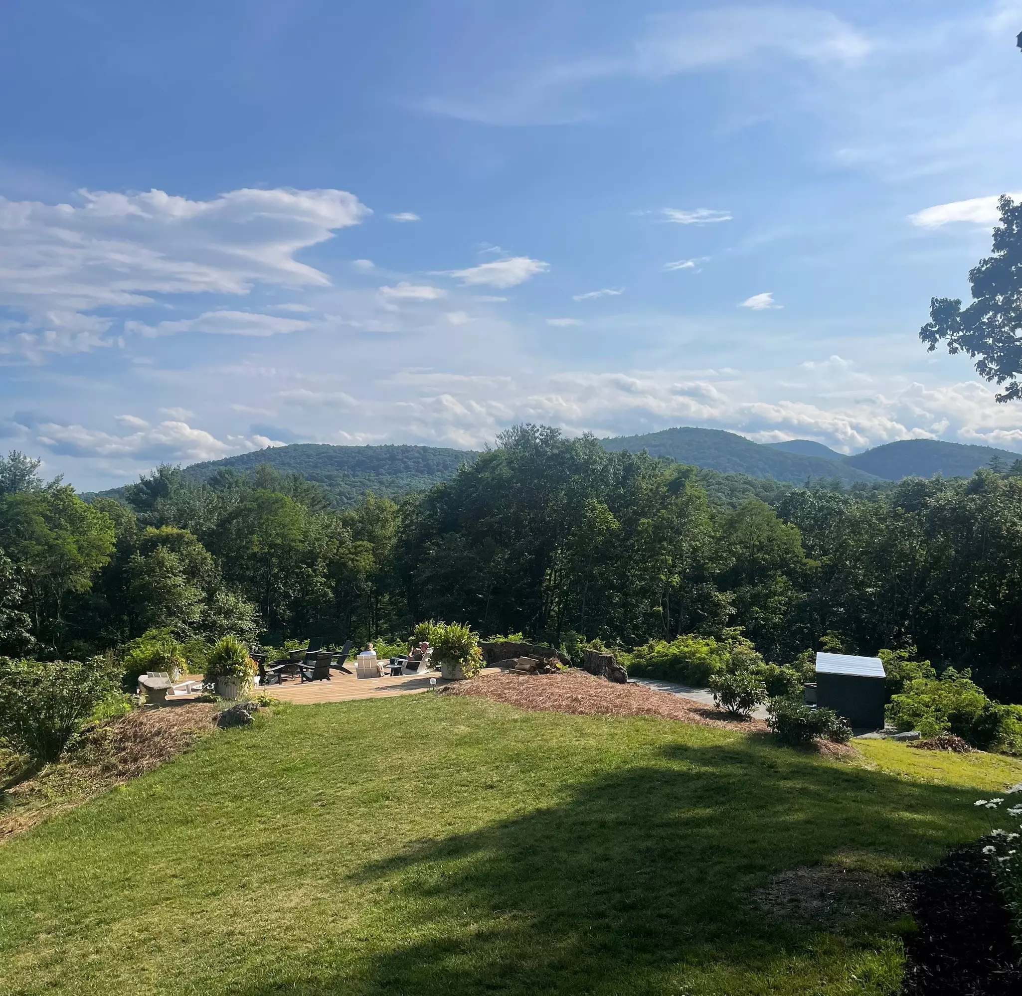 A scenic backyard with turf and a view over rolling hills