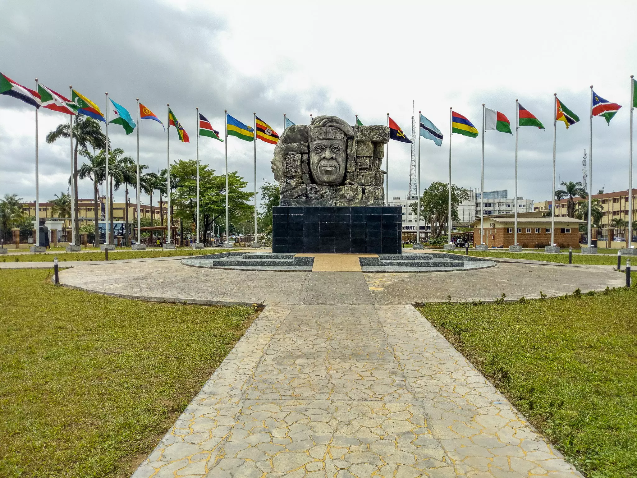 Flags surround a sculpture.
