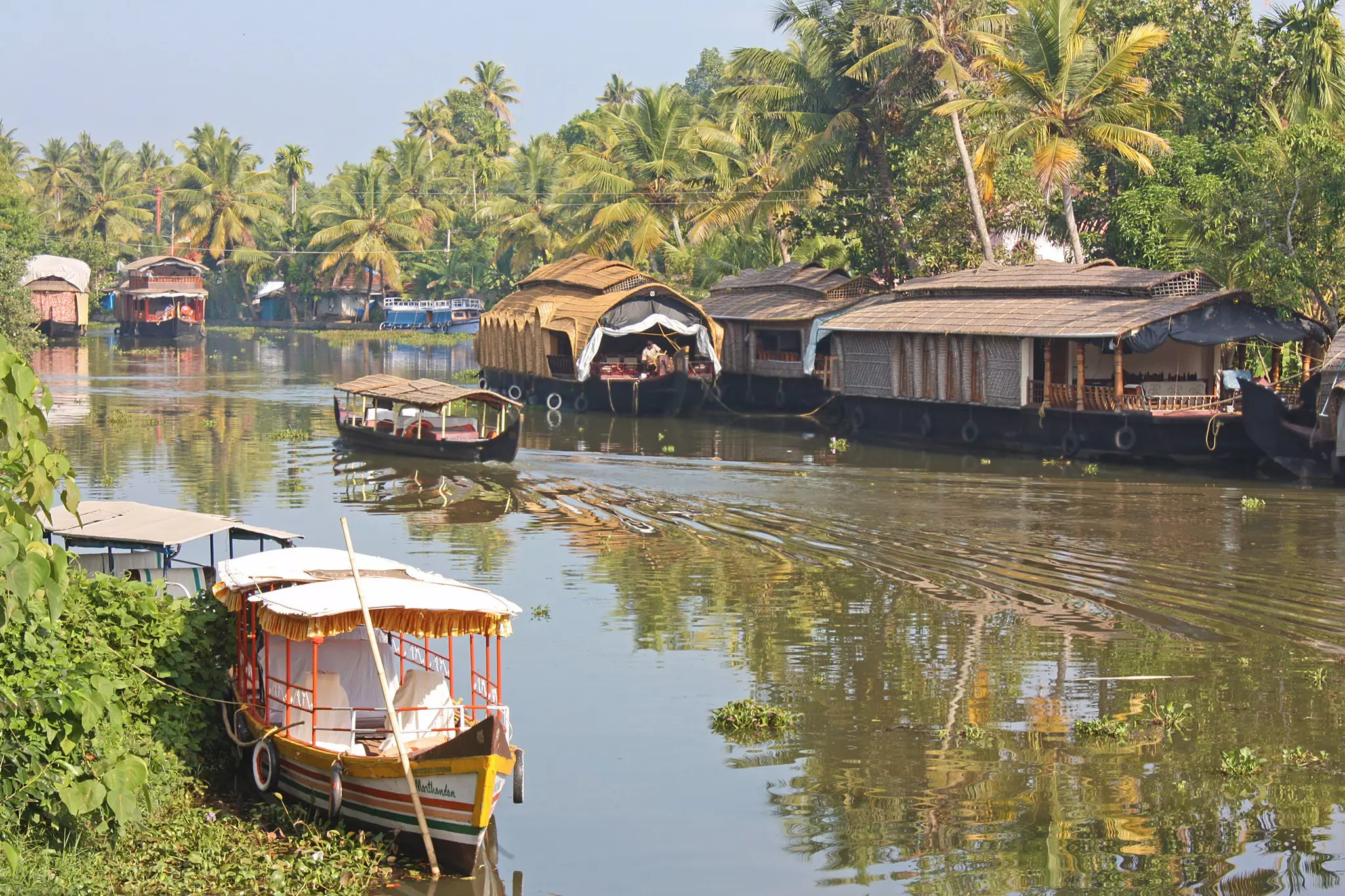 Houseboats floating in the Kerala backwaters, India.