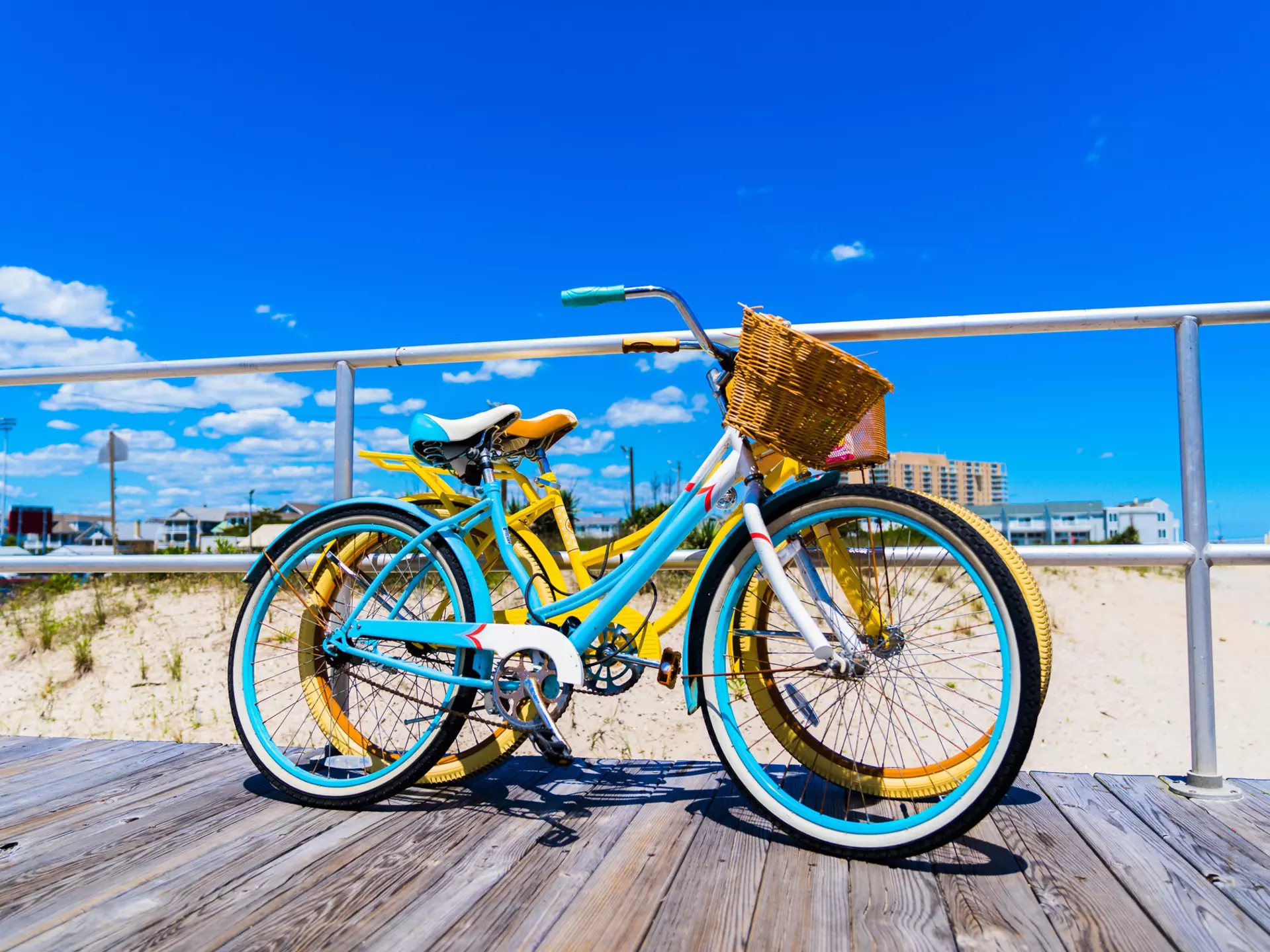 Vintage Style Bicycles Teal and Yellow on Ocean City New Jersey Boardwalk with Beautiful Blue Sky with some Clouds Vivid Colors  License Type: media  Download Time: 2021-08-27T15:06:18.000Z  User: AMccarthy_lonelyplanet  Is Editorial: No  purchase_order:
