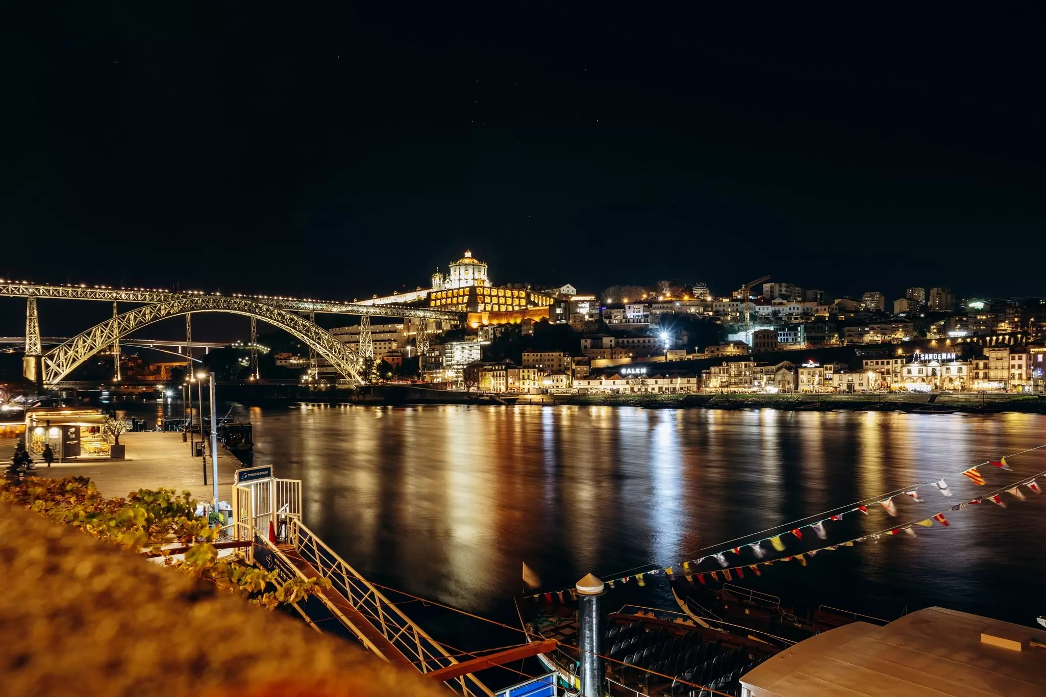 Night view of the Dom Luis I bridge over the Douro River and the illuminated Porto and Gaia riverfront