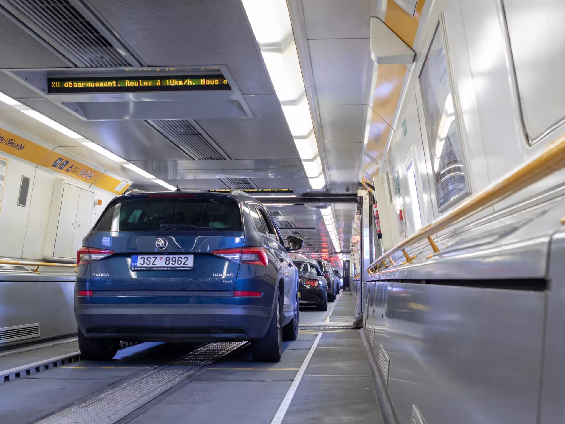 Cars lined up bumper to bumper inside a Eurotunnel train