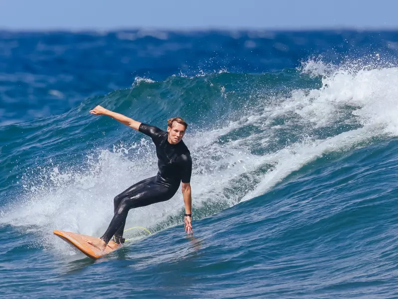 Surfers in action at the iconic Bells Beach on a warm summer's afternoon near Torquay, Victoria, Australia