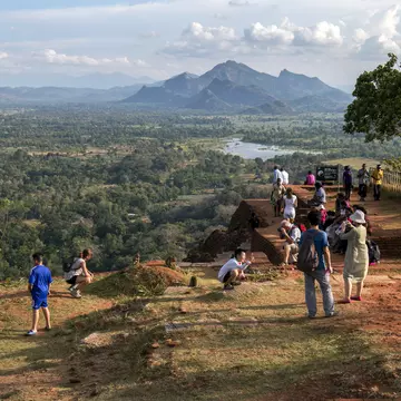 SIGIRIYA, SRI LANKA - JANUARY 20, 2013 : Visitors and a group of monkeys enjoy the late afternoon sun on the summit of Sigiriya Rock in central Sri Lanka.; Shutterstock ID 685100287;