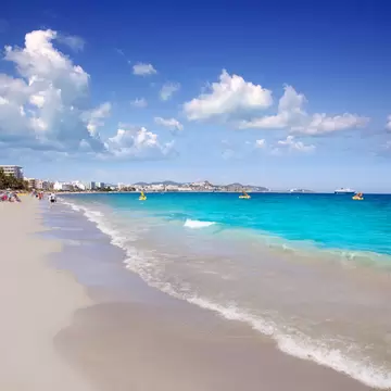 View of waves lapping onto the shore at Platja d'en Bossa on the island of Ibiza in Spain.