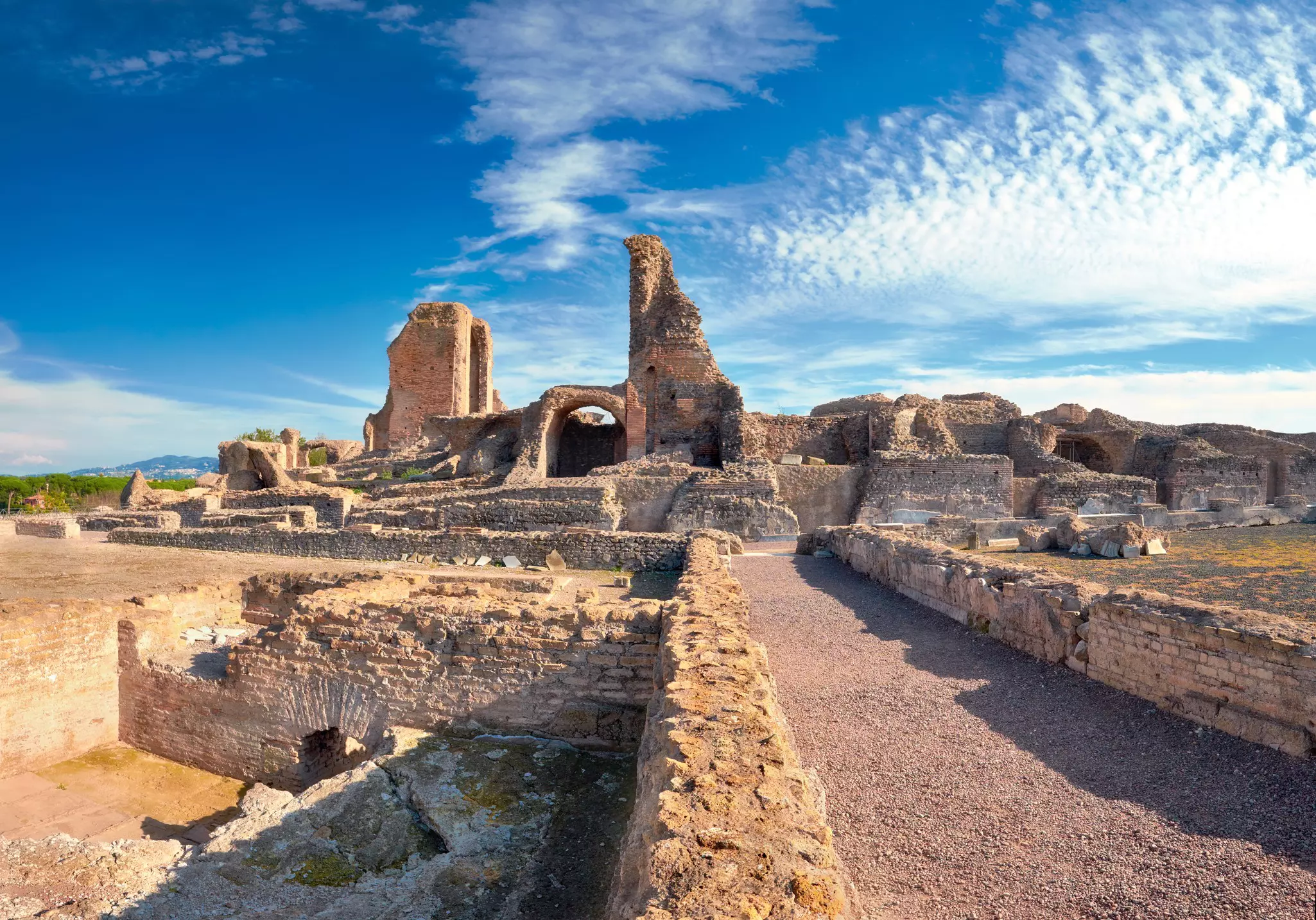 A pathway marked out by ruined walls leads to the remains on an ancient villa.