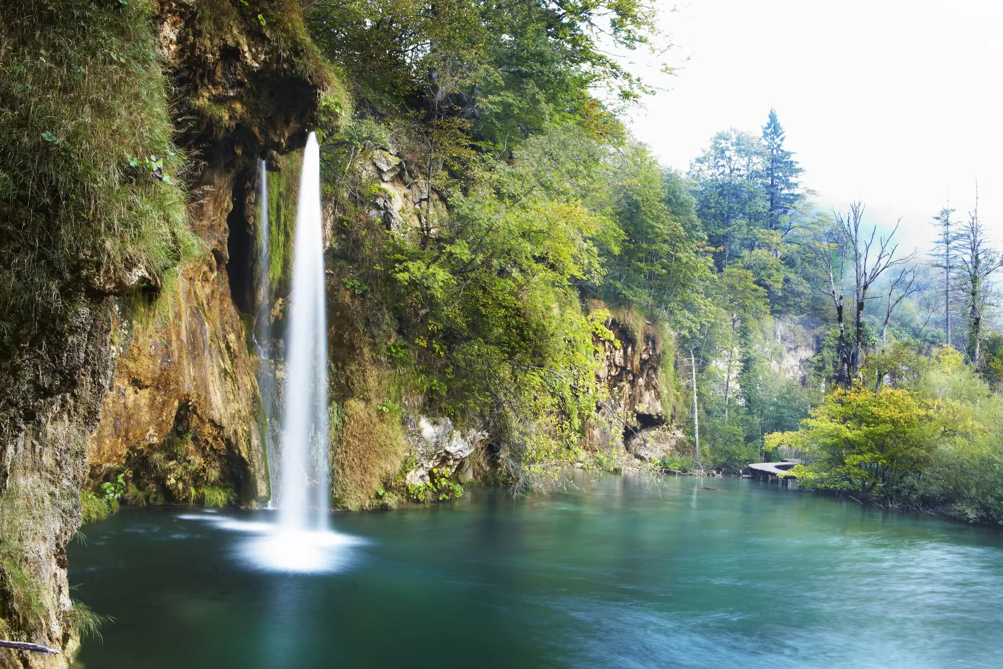 A waterfall cascading down into a lake