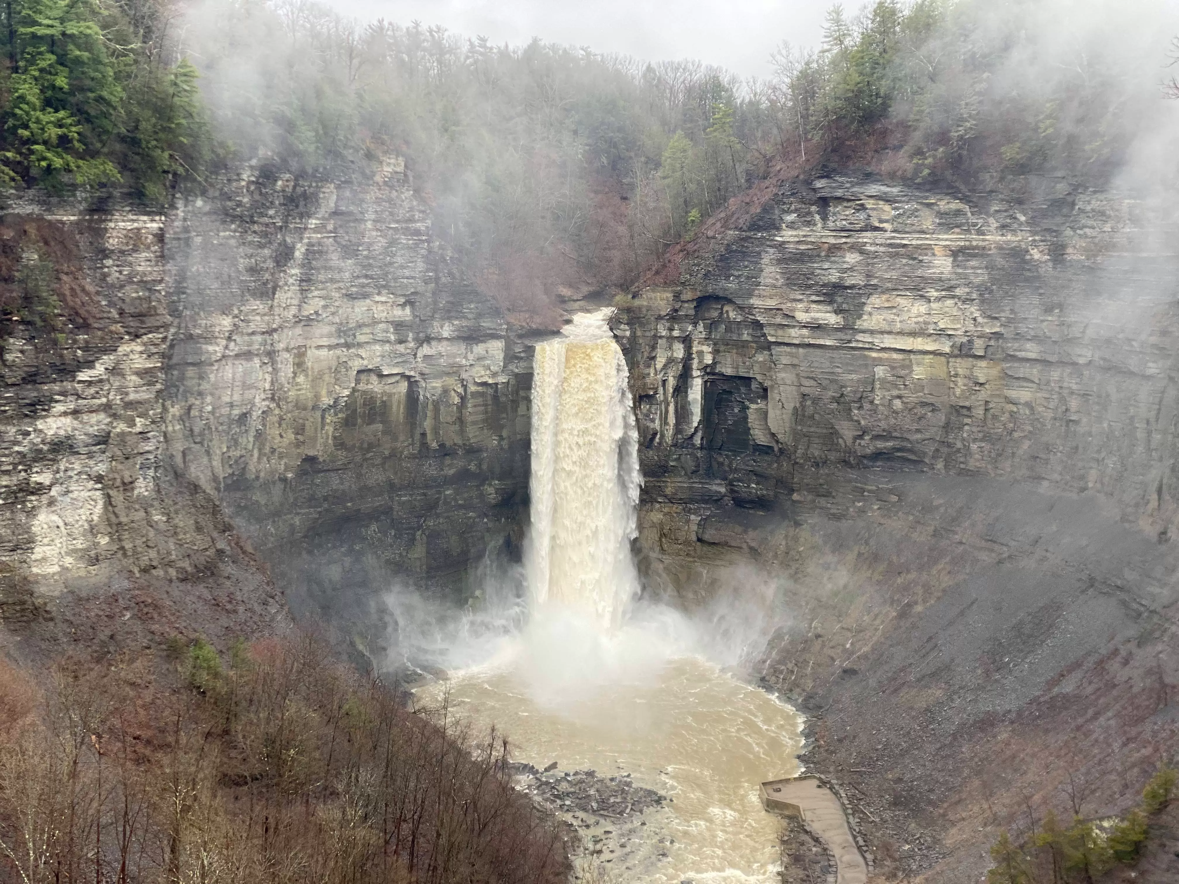 Taughannock Falls, the largest single-drop cascade in New York, as seen from its namesake park's upper viewing area. Spring 2024.