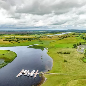 Aerial drone view of Shannon river and countryside rural irish landscape, Clonmacnoise monastery ruins and small marina with vacation river boats, county Offaly, Ireland, License Type: media, Download Time: 2025-12-04T16:42:27.000Z, User: nic.dhoedt_lonelyplanet, Editorial: false, purchase_order: 56530 - Guidebooks, job: Global Publishing WIP , client: Lonely Planet Ireland 17, other: Nicolas D'Hoedt