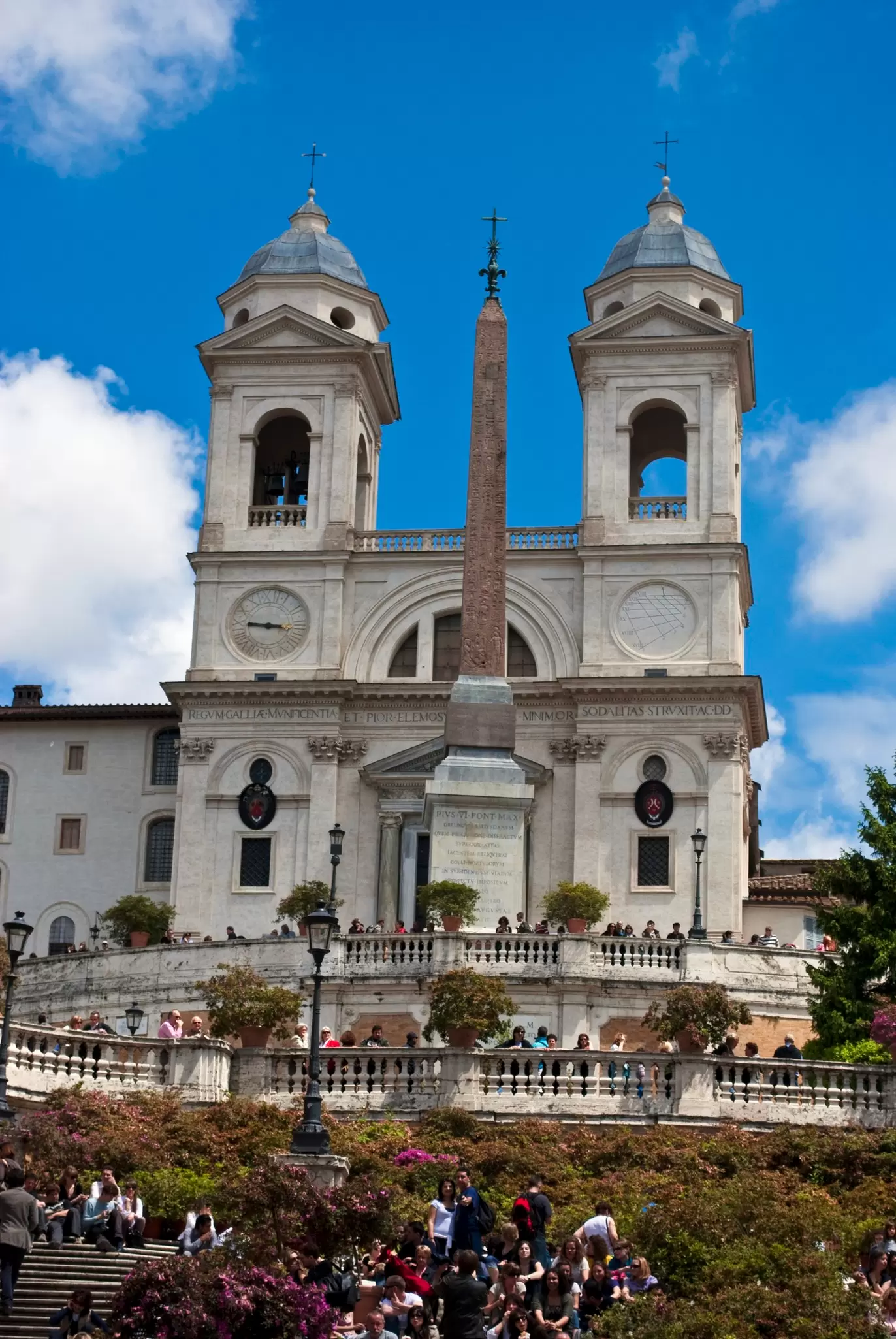 View of the Sallustian Obelisk at the top of the Spanish Steps, with the Chiesa della Trinità dei Monti in the background in Rome, Italy.