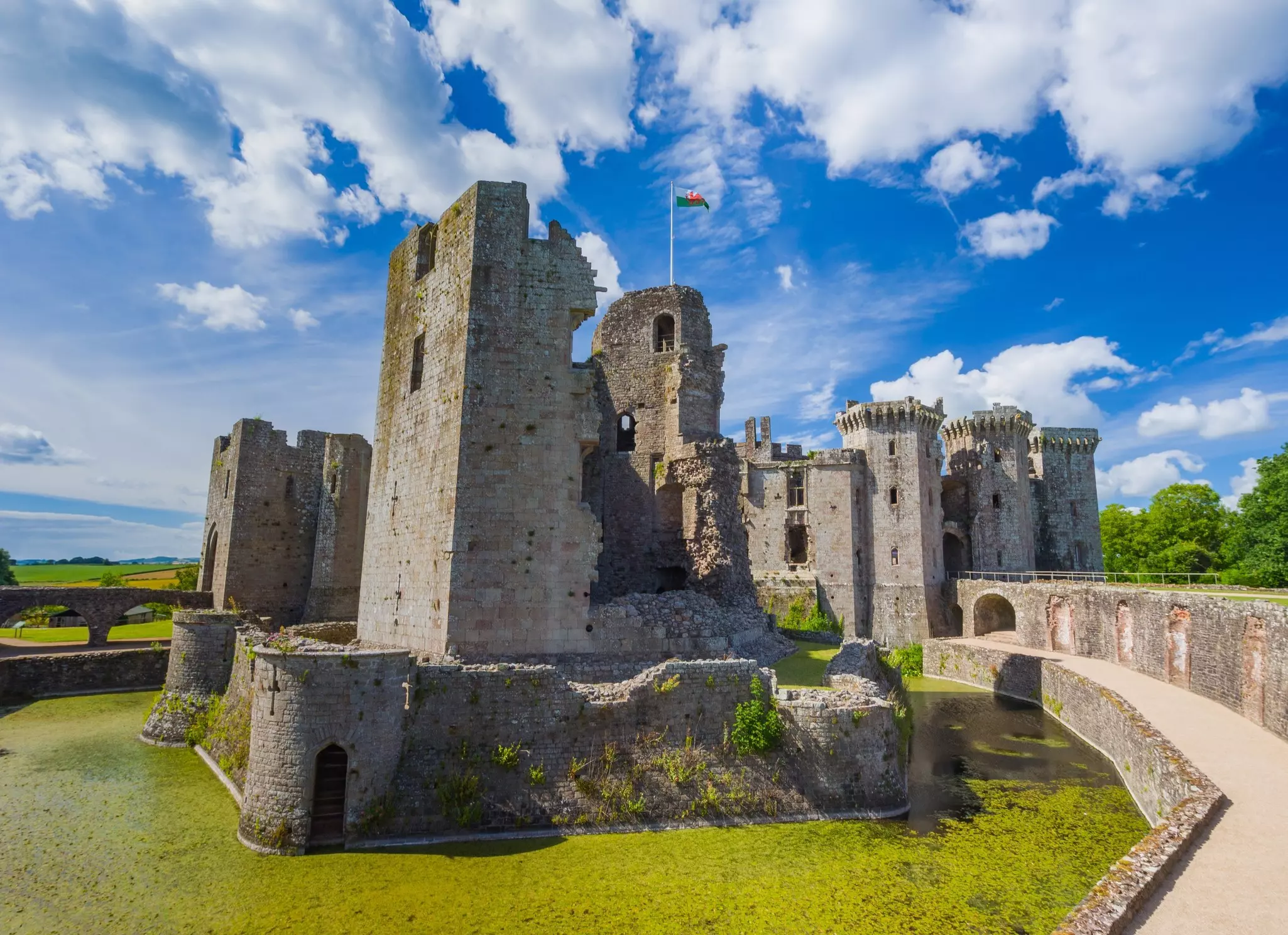 The ruined keep tower and moat of Raglan Castle, Wales.