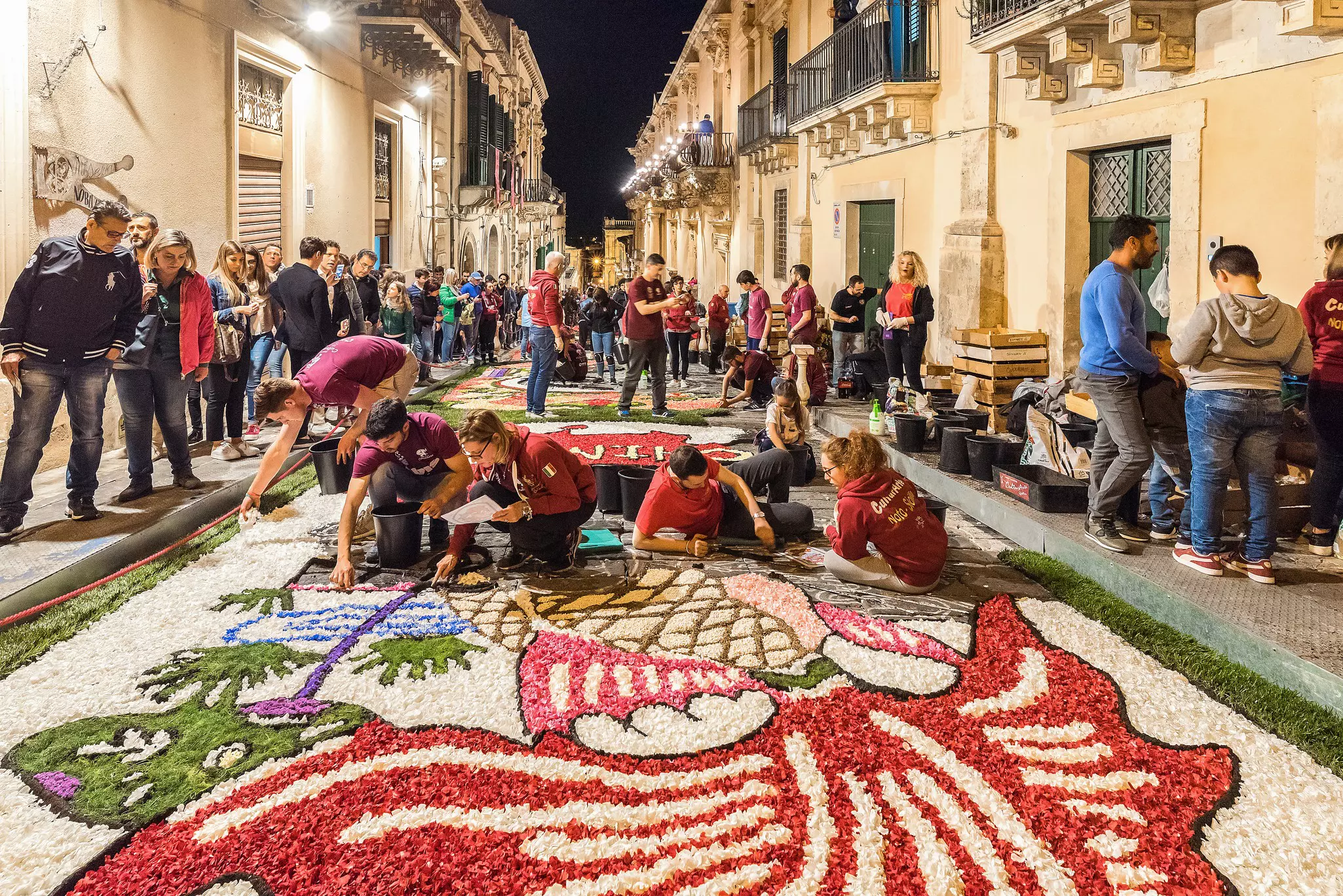 Artists create patterns of flower petals for the Infiorata festival in Noto in Sicily, Italy.